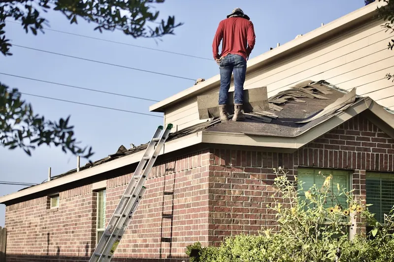 Professional roofer working on a residential roof in Buttes